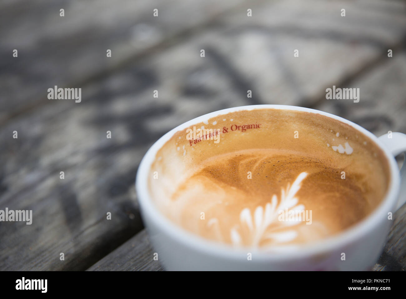 Eine Tasse Kaffee mit einem Fair Trade und Bio-Logo auf der Tasse mit Kopie Raum gedruckt. Stockfoto