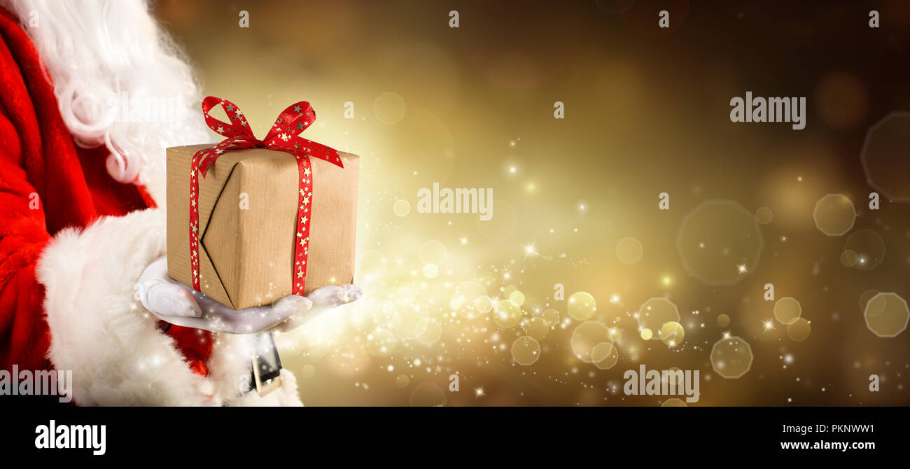 Ein Geschenk für Weihnachten - Vintage goldenen Hintergrund mit Weihnachtsmann mit Geschenk Stockfoto