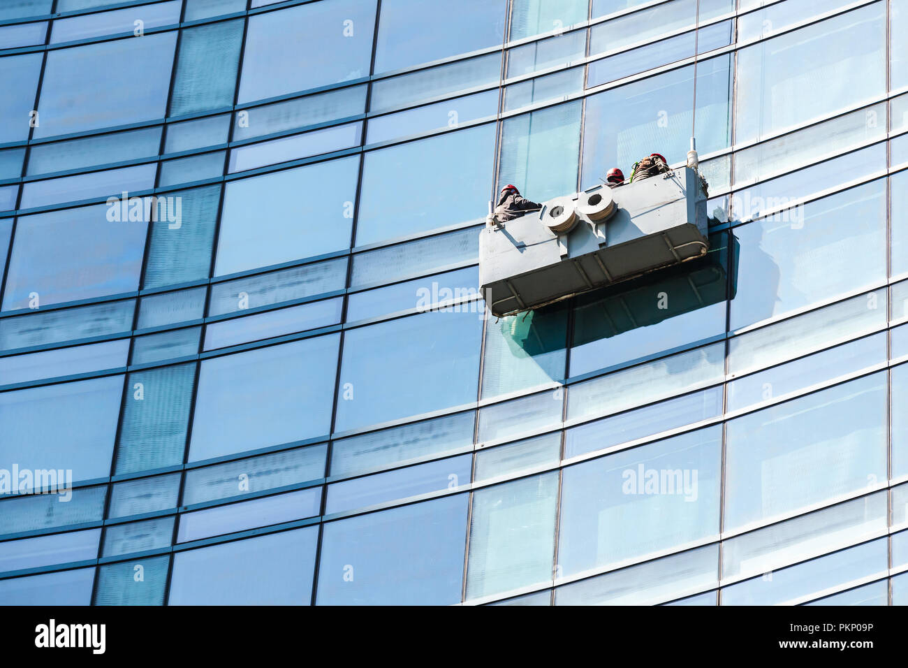 Bürogebäude Wartung, blauen Glasfassade Reinigung mit Ladestation Stockfoto