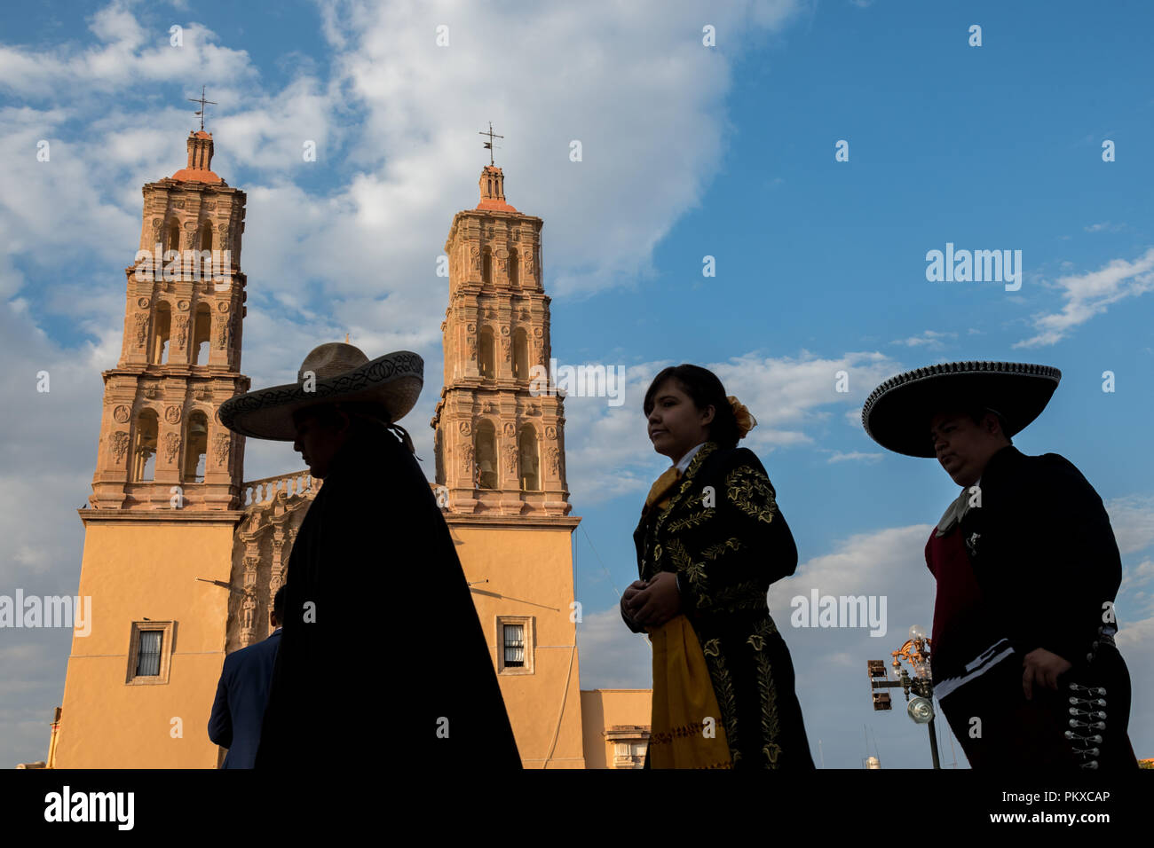 Mariachi Darsteller vor der Parroquia Nuestra Señora de Dolores Katholische Kirche silhouetted forderte auch die Kirche Unserer Lieben Frau der Schmerzen an der Plaza Principal in Dolores Hidalgo, Guanajuato, Mexiko. Miguel Hildago war ein Pfarrer, der inzwischen weltberühmten Grito - ein Ruf zu den Waffen für mexikanische Unabhängigkeit von Spanien ausgestellt. Stockfoto