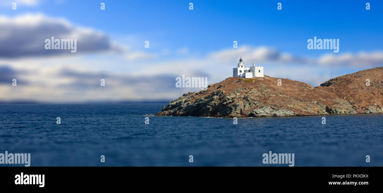 Leuchtturm und Agios Nikolaos Kirche auf felsigen Land. Kea, Tzia der sonnigen Insel, Griechenland. Blur bewölkter Himmel Hintergrund, Banner. Stockfoto