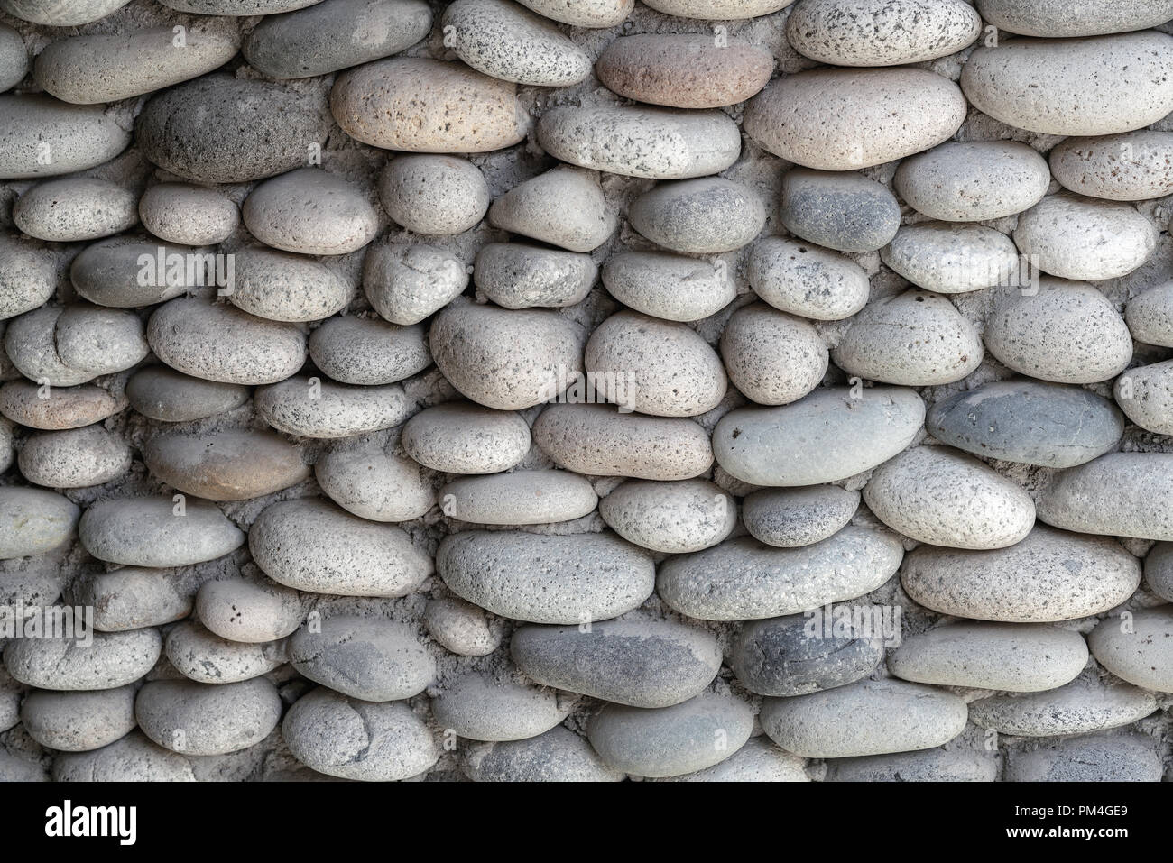 Wand Hintergrund. Durch kleine Steine. Dekoration und Architektur Konzept. Stockfoto