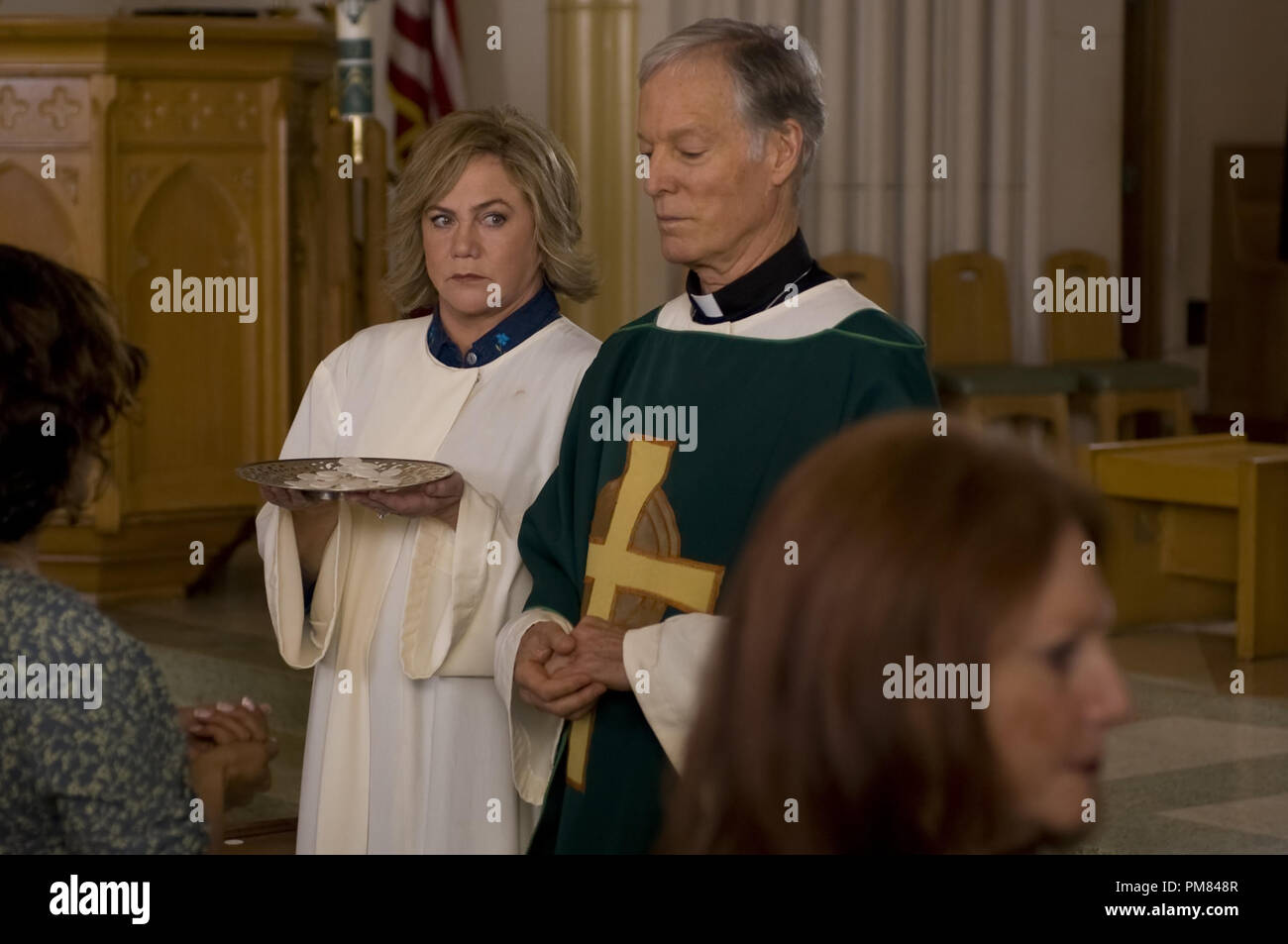 Eileen Cleary (Kathleen Turner) und Monsignor Murphy (Richard Chamberlain) an der Kirche in einer Szene aus der perfekten Familie. Foto von Oana Marian/Höflichkeit Varianz Filme / Die perfekte Familie LLC. Stockfoto