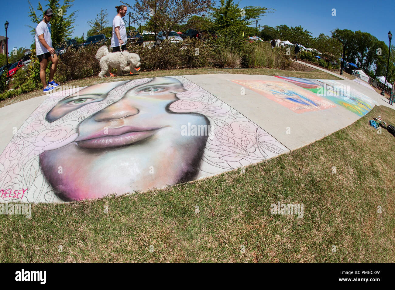 Menschen gehen durch detaillierte Chalk Kunst auf einem Bürgersteig am Lawrenceville Arts Fest am 28. April 2018 in Lawrenceville, GA. Stockfoto