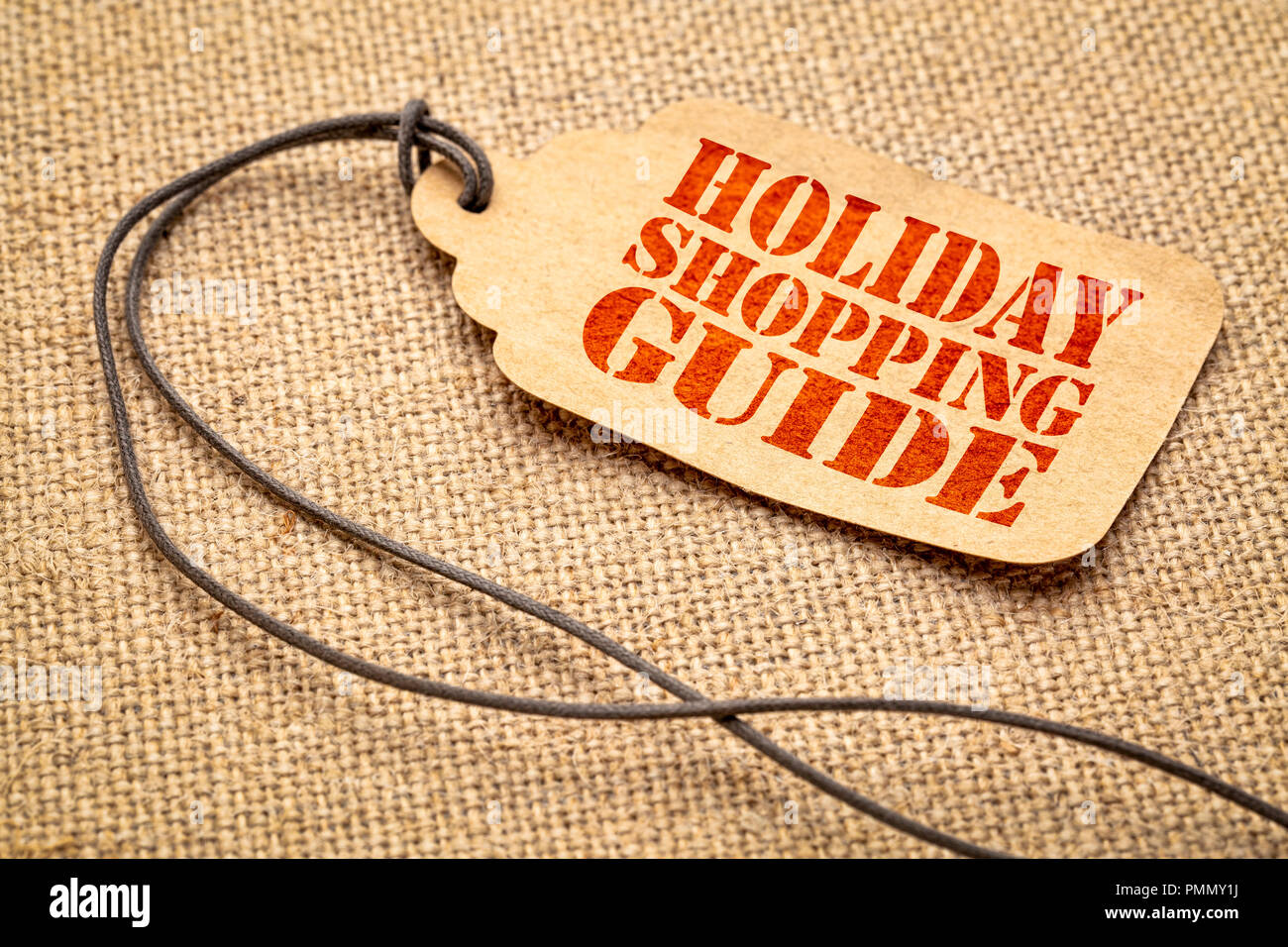Holiday Shopping Guide Zeichen - ein Papier Preis Variable mit einem Garn iagainst Leinwand Leinwand Stockfoto
