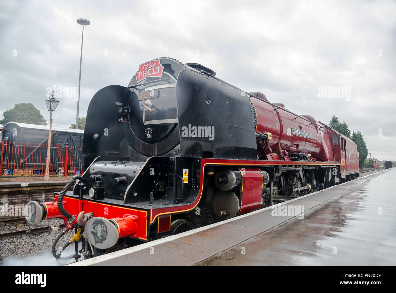 Kidderminster, Großbritannien. 20. September, 2018. UK Wetter: Das Personal an der Severn Valley Railway Soldat auf, obwohl der Regen fort. Anhaltender Regen nicht die Geister der Angestellten oder Reisenden Dämpfen wie der Besuch 6233 Dampflok, Herzogin von Sutherland, fährt von Kidderminster station Überschrift nach Bridgnorth. Anfahren, er wirft aus Federn von Dampf in die feuchte Luft auf den frühen Morgen laufen für den Beginn des SVR Herbst Dampf Gala. Quelle: Lee Hudson/Alamy leben Nachrichten Stockfoto