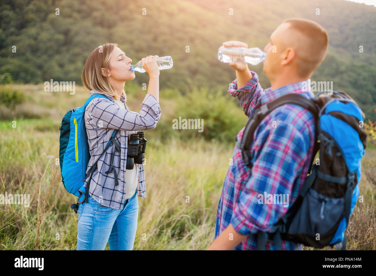 Glückliches Paar ist Wandern in den Bergen. Sie sind Trinkwasser. Stockfoto