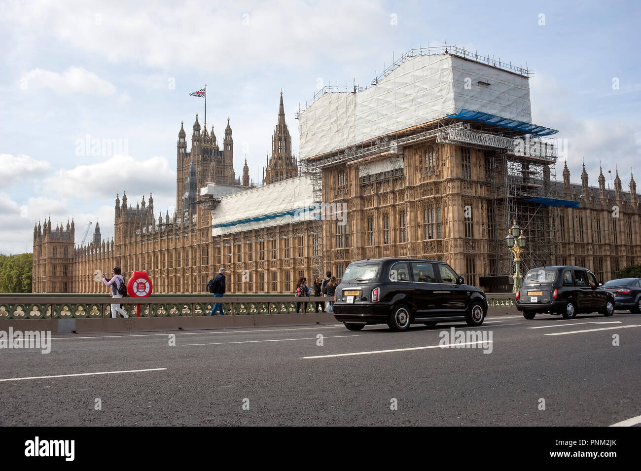 Gerüste und Schutzfolie über Palast von Westminster bei Renovierungsarbeiten, wie von Westminster Bridge gesehen. Stockfoto