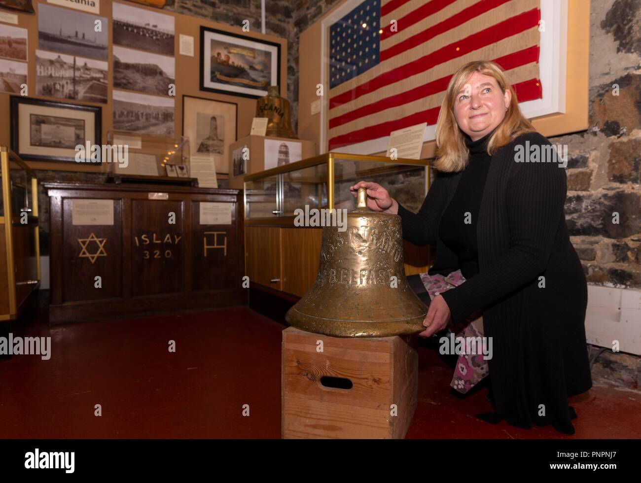 Islay, UK. 22. September 2018. Die Schiffsglocke, die der SS Otranto, die in Machir Bay vor der Küste der schottischen Insel Islay versenkt wurde in das Museum von Islay Leben in Port Charlotte gegangen. Bild: Museum Manager, Jenni Minto mit der Glocke der SS Otranto. Im Hintergrund ist ein Kennzeichen, das Museum von der Credit ausgeliehen worden ist: Reiche Dyson/Alamy leben Nachrichten Stockfoto