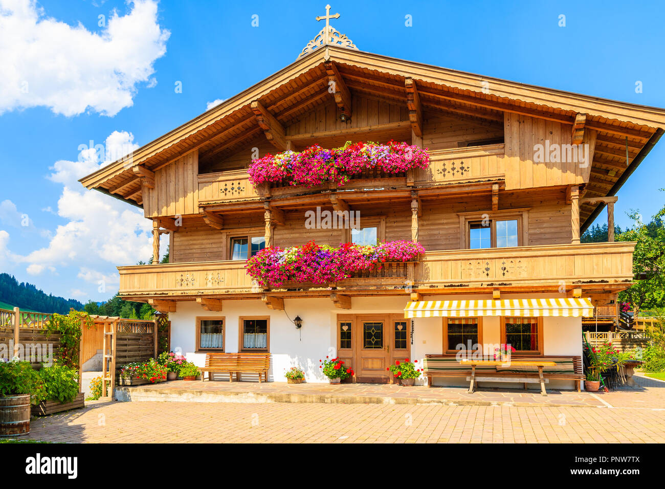 Traditionelle Holz- Haus mit Blumen in einem kleinen Dorf in der Nähe von Kitzbühel, Tirol, Österreich eingerichtet Stockfoto