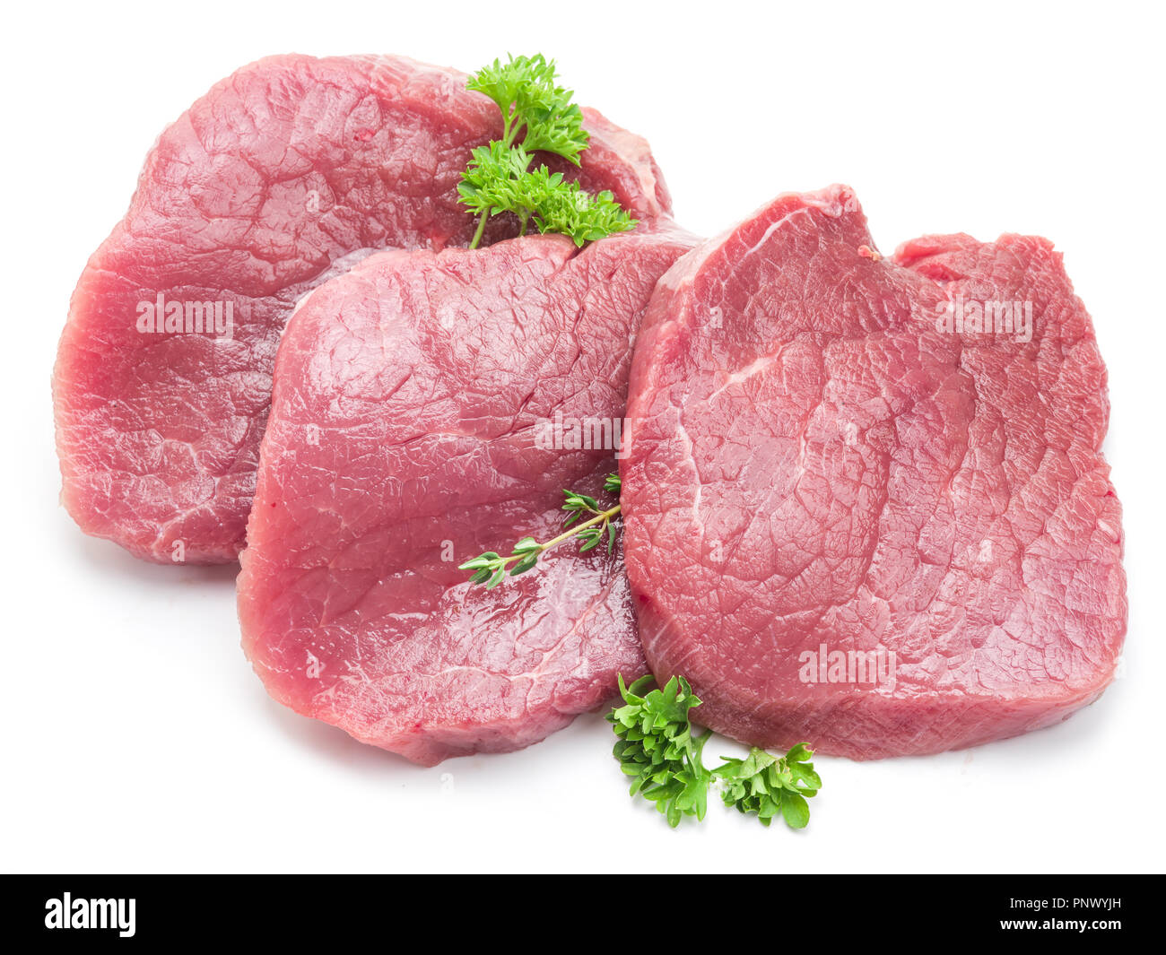 Raw beaf Steaks mit Petersilie auf einem weißen Hintergrund. Stockfoto