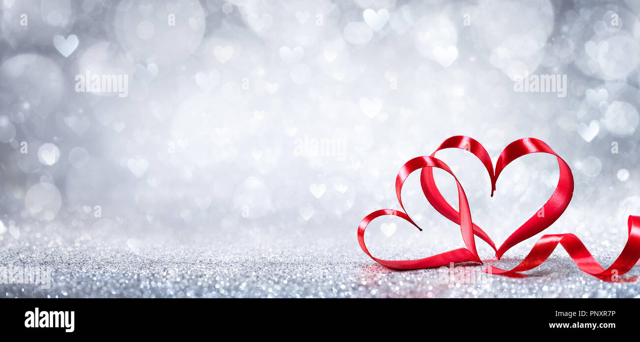Valentinstag Dekoration - Ribbon geformte Herzen auf glänzenden Hintergrund Stockfoto