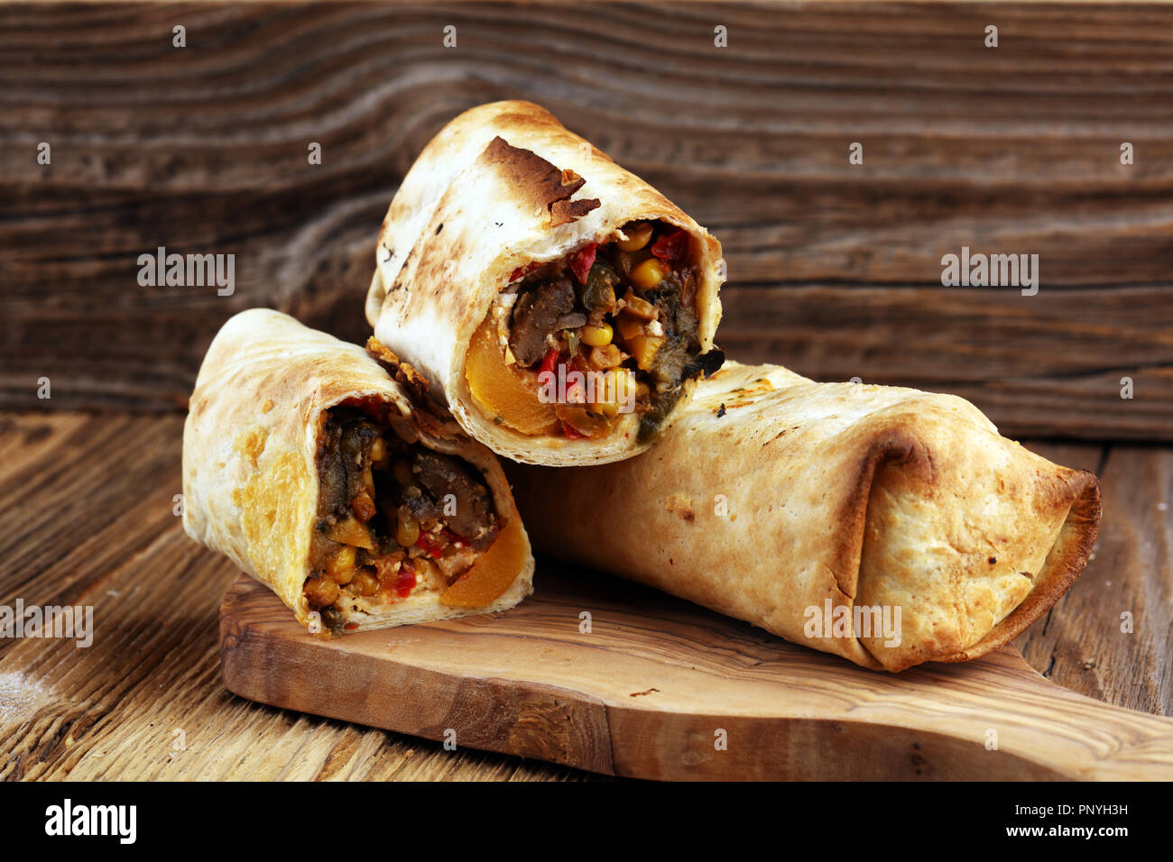 Burritos Wraps mit Rindfleisch und Gemüse auf Holz- Hintergrund. Beef burrito, mexikanisches Essen. Stockfoto