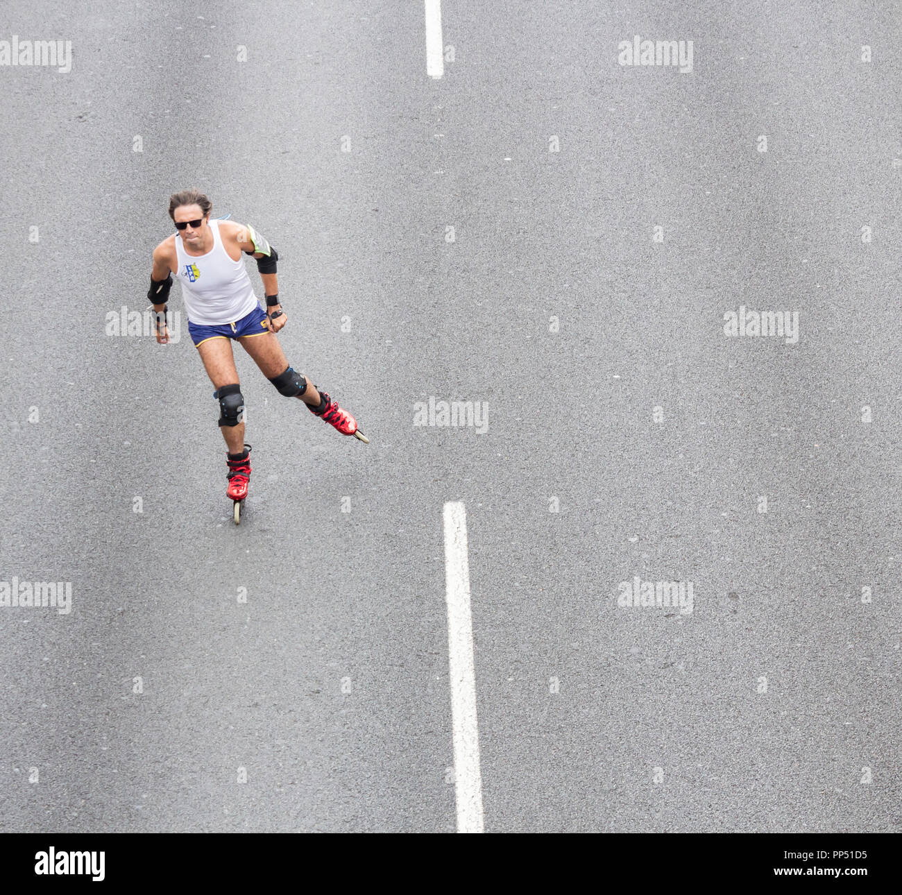 Drone-Ansicht von Mann-Rollerblading, Inline-Skating auf der Straße Stockfoto