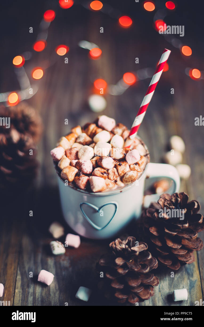 Weihnachten heiße Schokolade mit Marshmallows auf einem rustikalen Holztisch mit kiefernzapfen und rote Ampeln. Selektiver Fokus Stockfoto