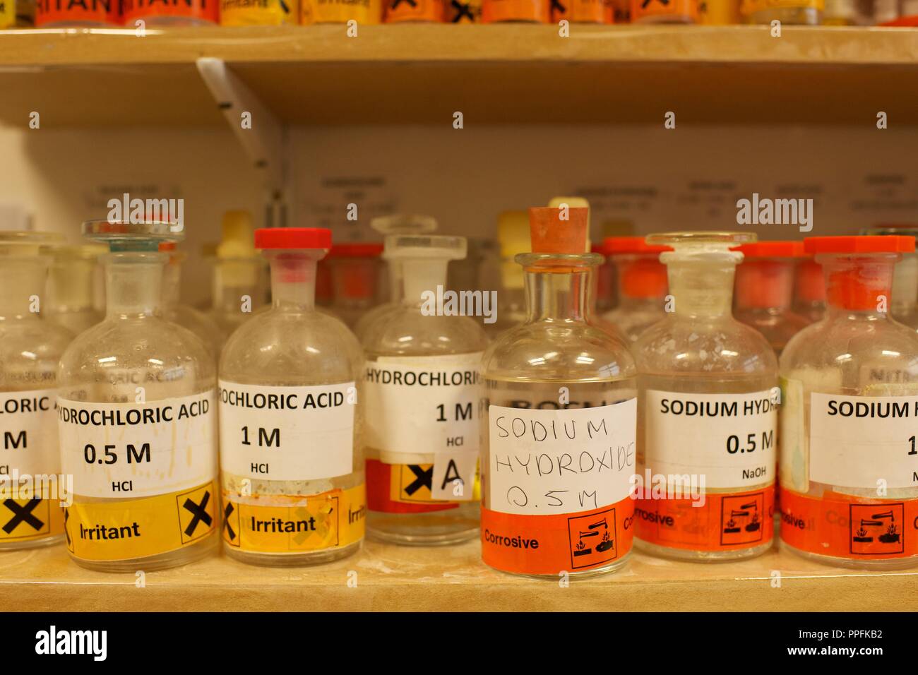 Verschiedene Flaschen mit Chemikalien einschließlich Natriumhydroxid in einer Schule Chemie Labor Stockfoto