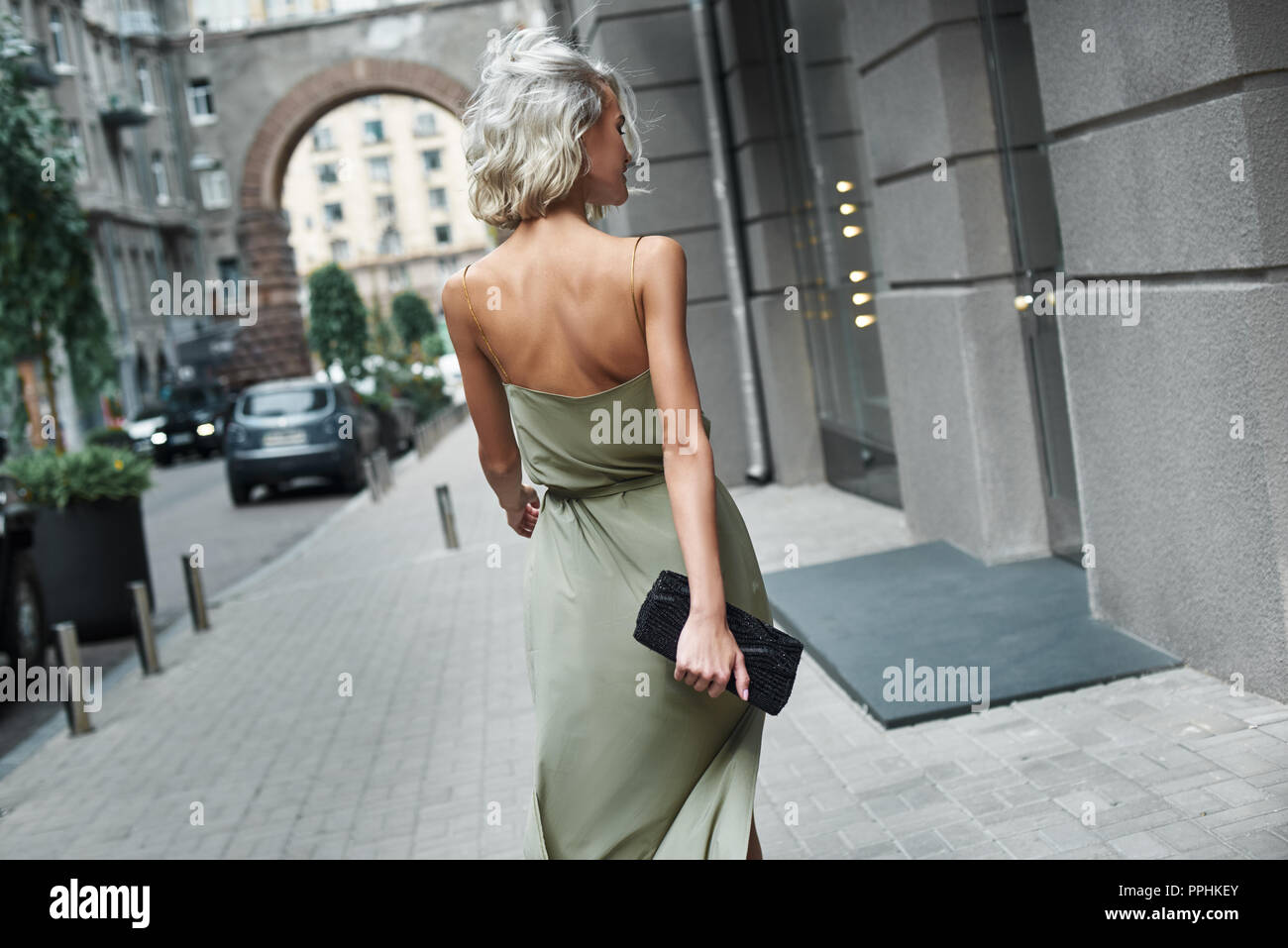 Mode. Junge stilvolle Frau, die zu Fuß auf der Straße zurück, windigen Wetter Stockfoto