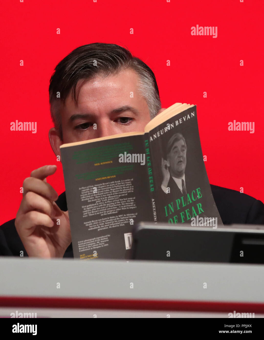 Shadow Gesundheit Sekretärin Jon Ashworth liest ein Buch, bevor er seine Rede an der jährlichen Konferenz der Labour Party in der Arena und Convention Center (ACC), in Liverpool. Stockfoto