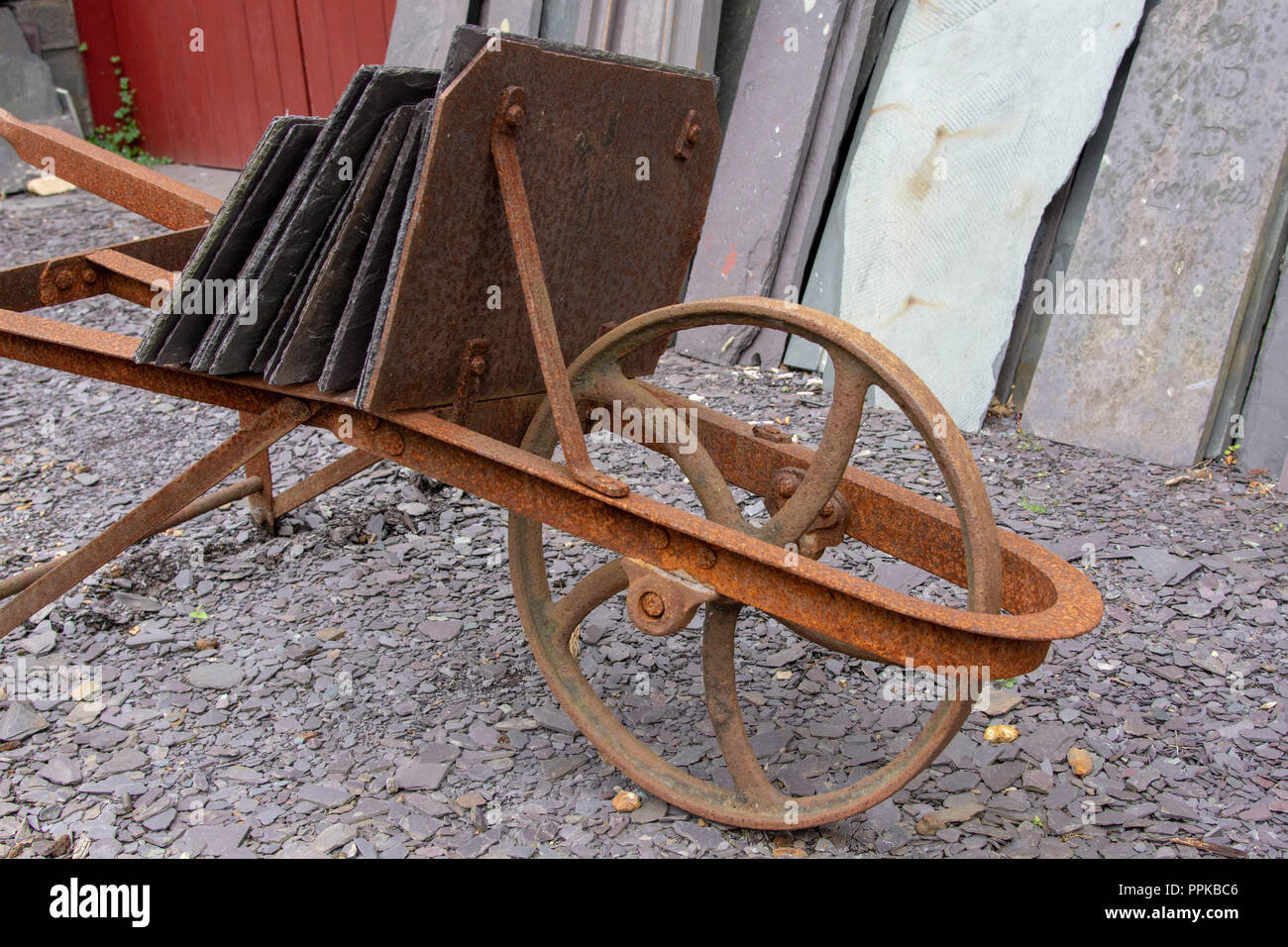 Metall Schubkarre mit Schiefer auf es Stockfoto