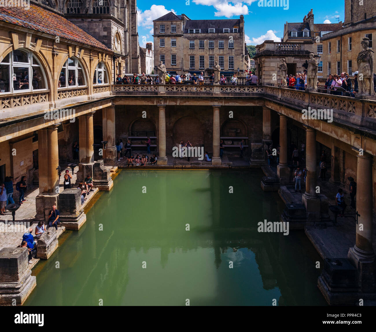 Besucher erkunden die Terrasse und großer Badewanne der Römischen Bäder, in der historischen Stadt Bath, Somerset, England, UK. Stockfoto