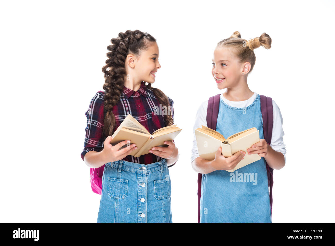 Schüler hält geöffnete Bücher und an jedem anderen Suchen isoliert auf weißem Stockfoto