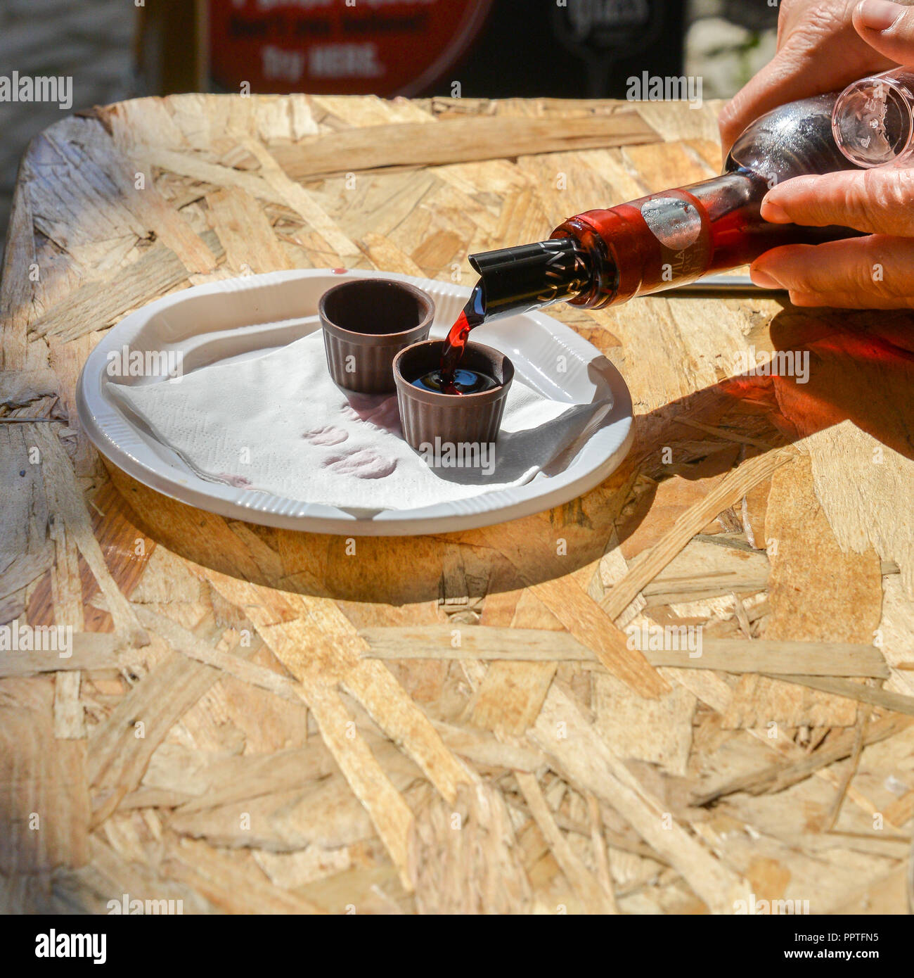 Ginja de Obidos, traditionelle Sauerkirschen Likör, in kleinen Schalen aus Schokolade serviert. Stockfoto