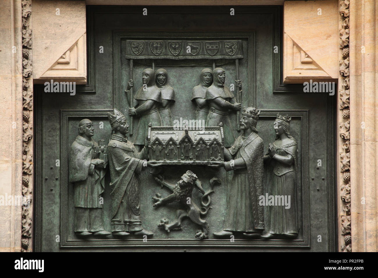 Kaiser des Heiligen Römischen Reiches Karl IV. und seine Frau Anna von schweidnitz (Anna Svídnická) Präsentation der Schrein mit den Reliquien des heiligen Vitus Erzbischof Arnošt von Pardubice (Arnošt z Pardubic). Bronze Relief von Tschechischen Bildhauer Otakar Španiel nach tschechischen Künstler Vratislav Hugo Brunner (1926-1929) auf das Tor von St. Vitus Kathedrale in Prag Schloss in Prag, Tschechische Republik. Stockfoto