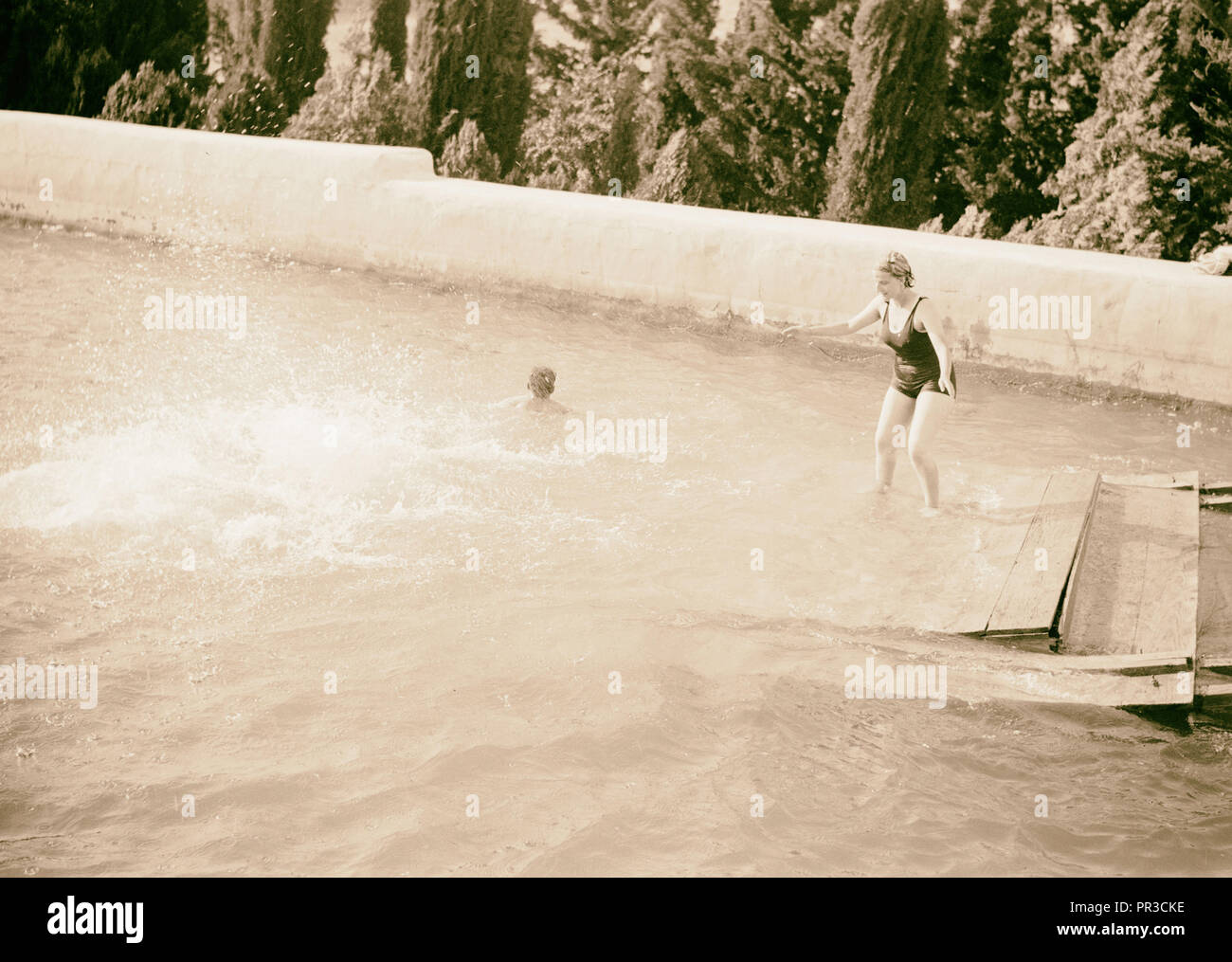 Salomos Pools wird ein Picknick & Schwimmen resort Badegast Balancieren auf floss nach anderen Insassen im Splash verschwinden. 1940 Stockfoto