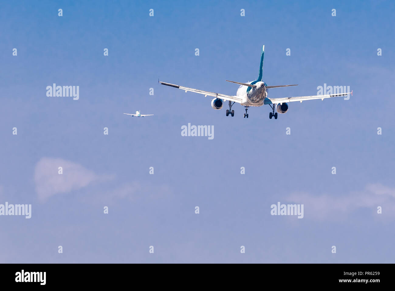 Zwei große Flugzeuge, eine Landung und ein weiterer sich aus dem Flughafen Stockfoto