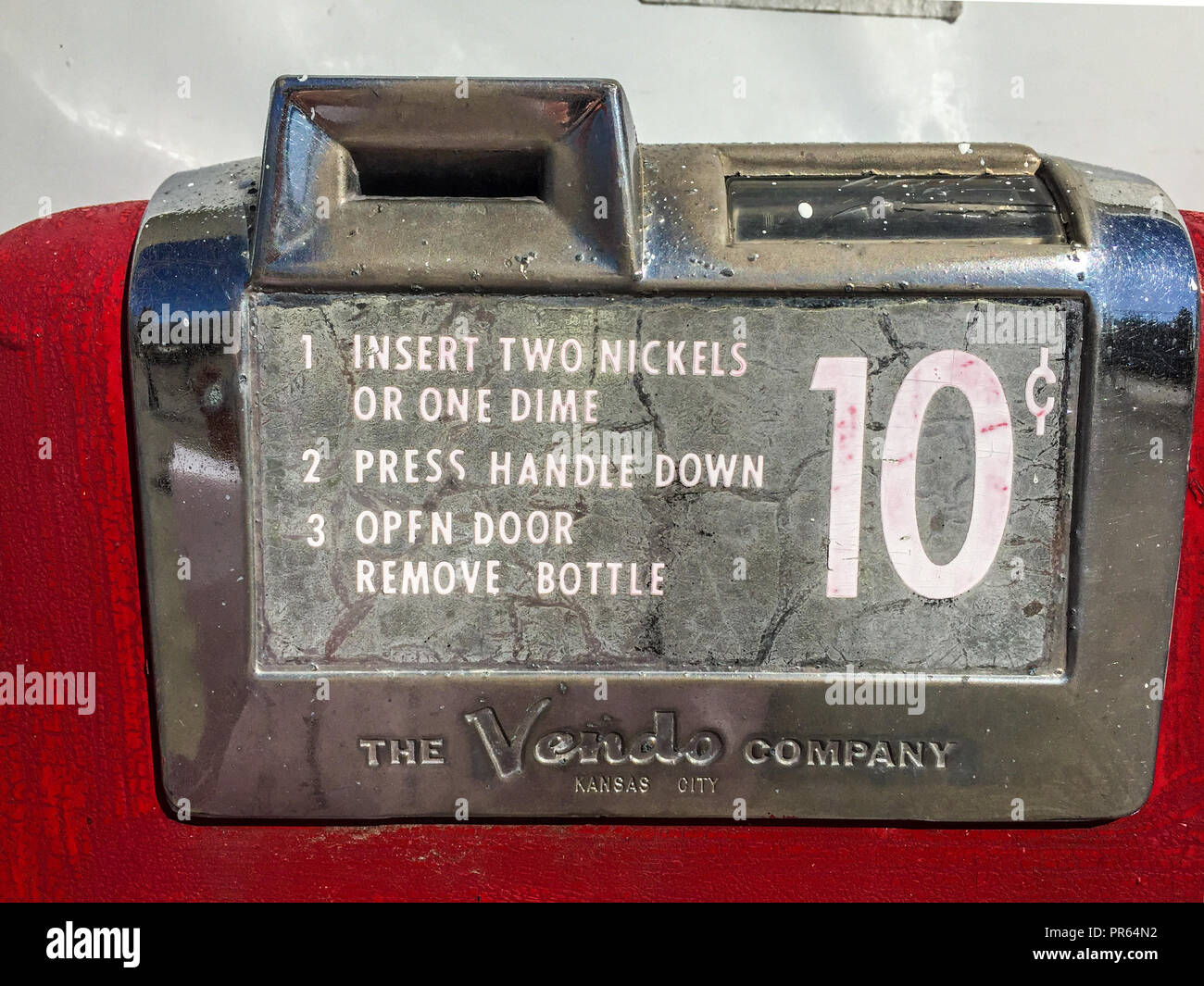 Detail eines alten Coca Cola Dispenser mit 10 cent Slot und dem Namen des Herstellers - die Firma Vendo, Kansas City Stockfoto