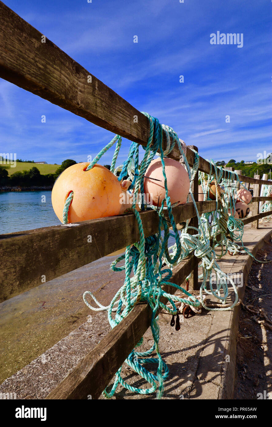 Angeln schwebt an den Zaun in der Nähe des Eingangs zu Pascoes Bootswerft, Roseland, Cornwall gebunden Stockfoto