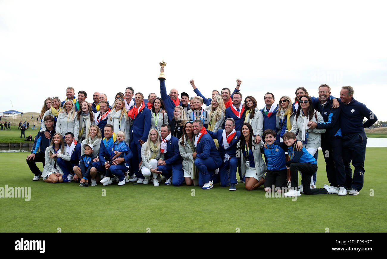 Team Europa Kapitän Thomas Bjorn feiert mit dem Ryder Cup Trophäe neben Spieler und deren Frauen und Freundinnen an Tag drei des Ryder Cup bei Le Golf National, Saint-Quentin-en-Yvelines, Paris. Stockfoto