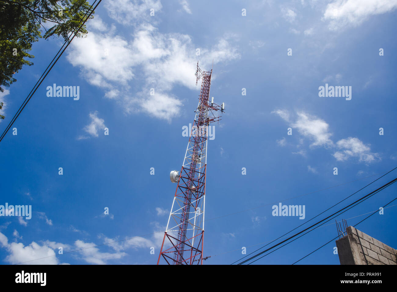 Rot und weiss Weiterempfehlen Telefon signal Zelle Turm erhebt sich gegen den blauen Himmel im Sommer Stockfoto