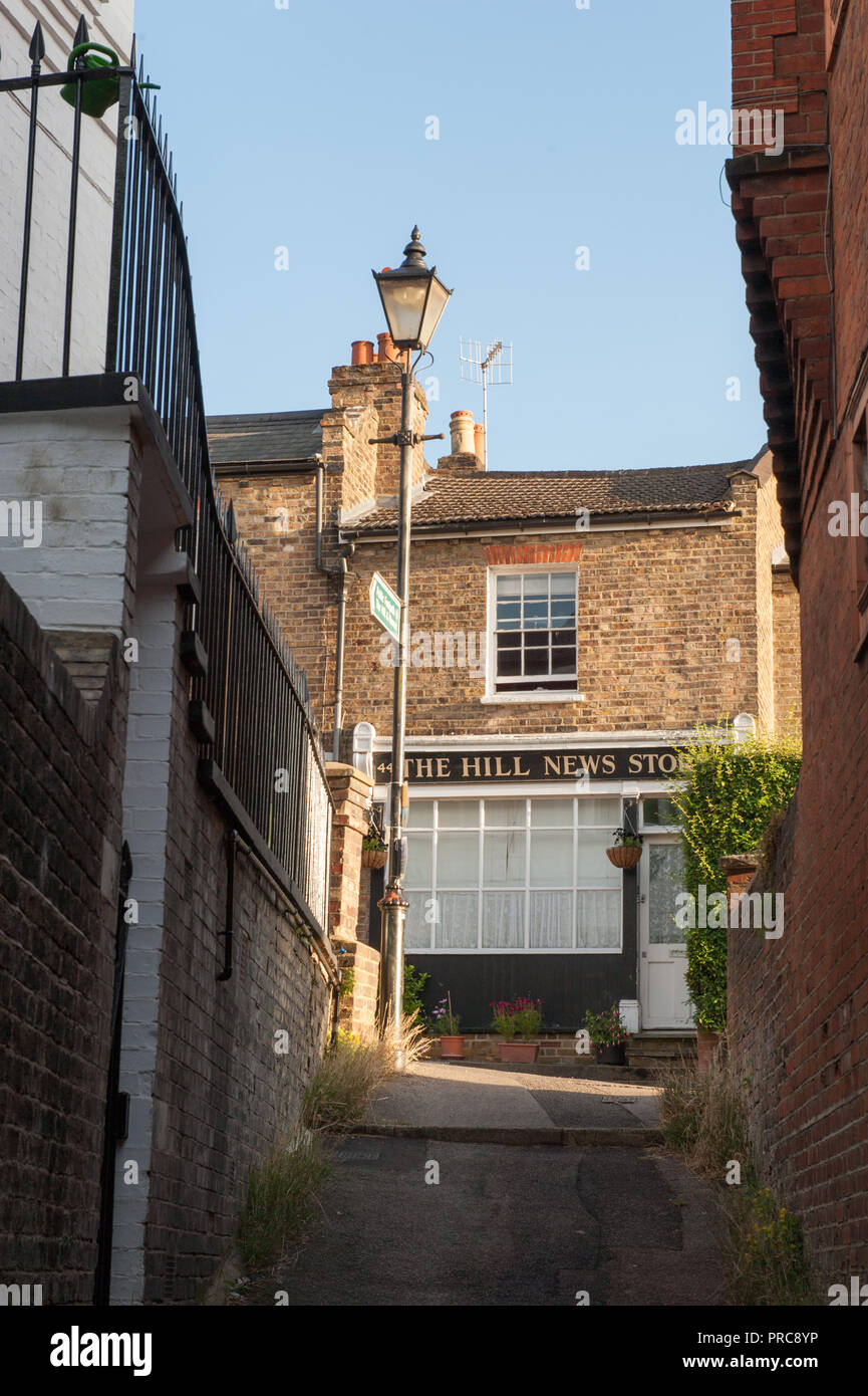 West Street im Londoner Stadtteil Harrow im Nordwesten Londons mit Reihenhäusern auf einem hügeligen Straße Stockfoto