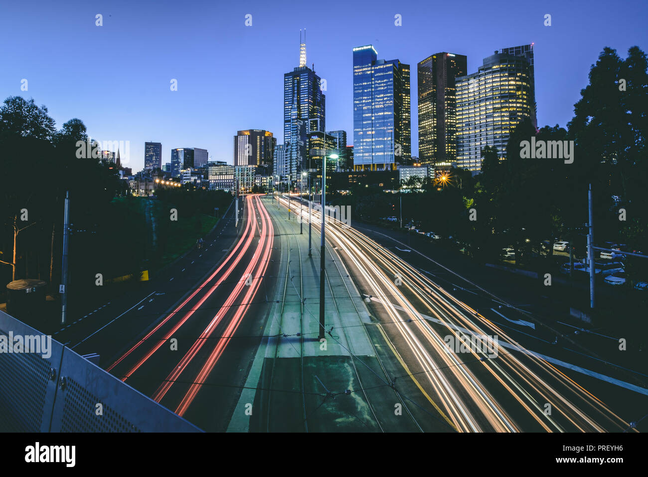 Melbourne Skyline in der Abenddämmerung mit Licht Wanderwege, Australien Stockfoto