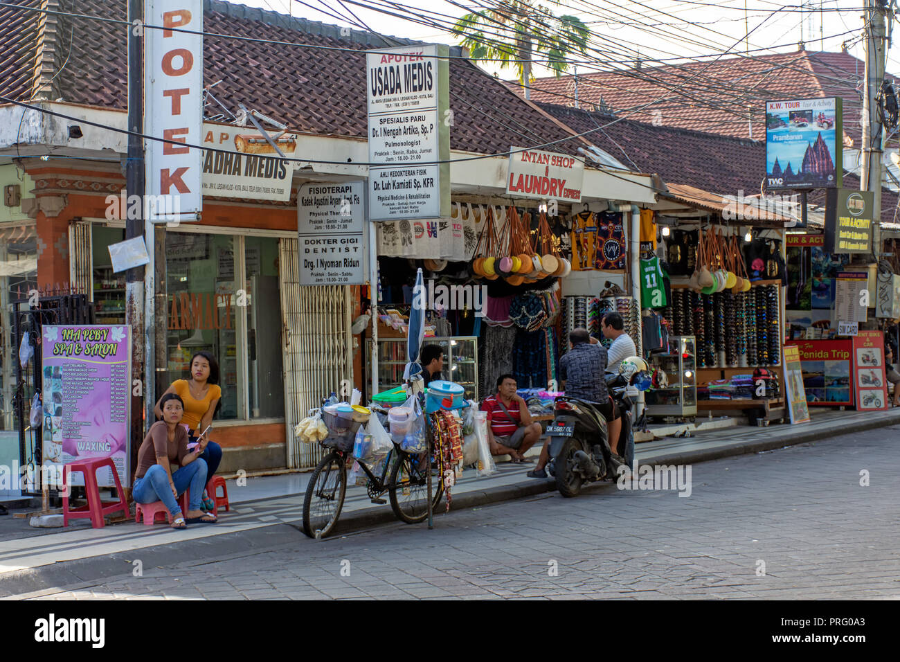 Kuta, Indonesien - 14. September 2018: Anbieter warten auf Kunden im Legian Street. Legian ist berühmt unter Touristen für Disco und Unterhaltung. Stockfoto