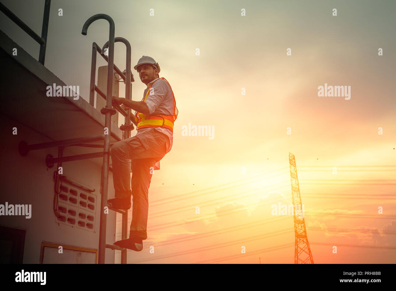 Ingenieur Techniker an der Leiter arbeiten Strom Kabel line Sonnenuntergang Hintergrund zu beheben Stockfoto