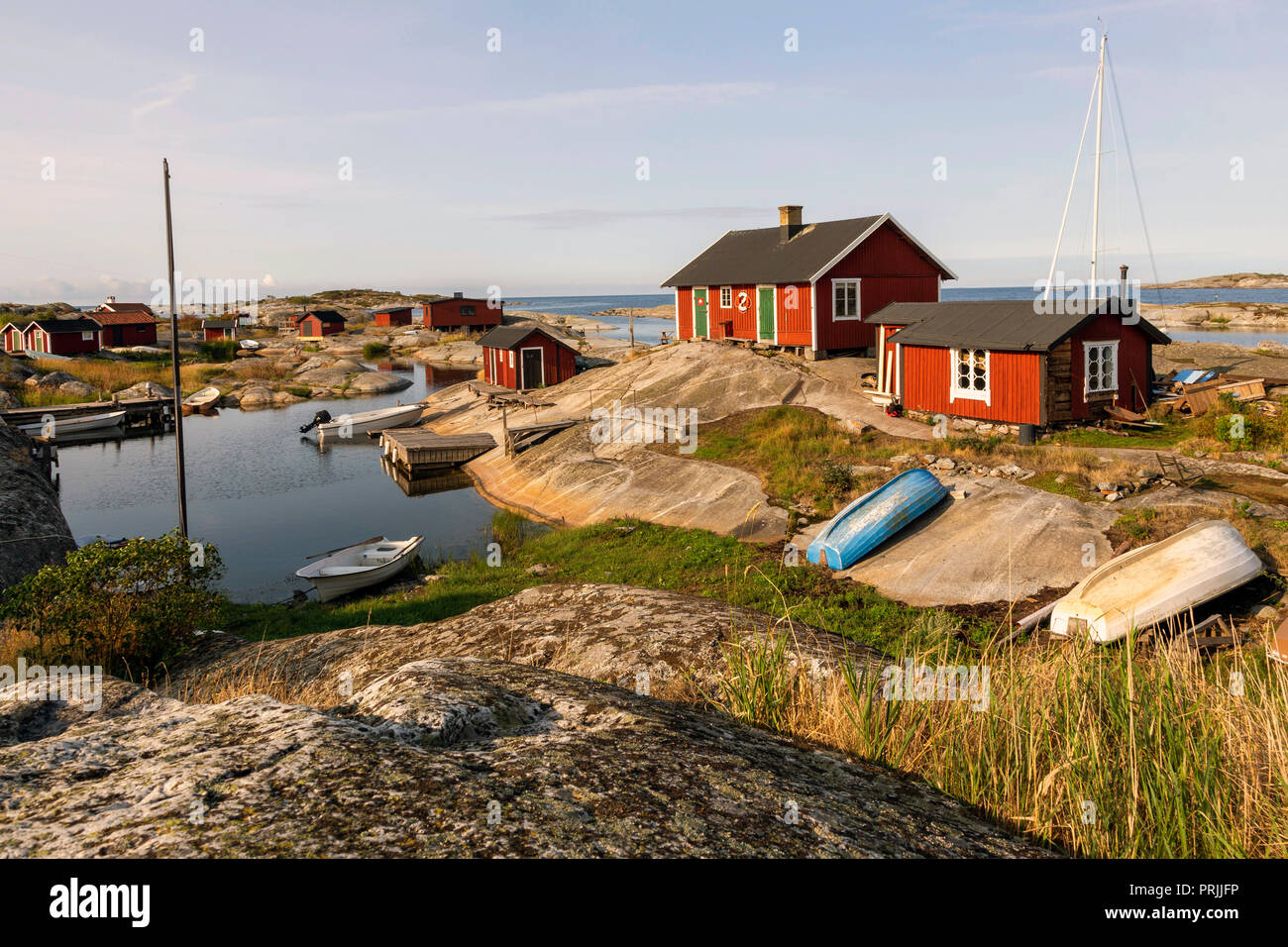 Rote Holzhäuser an der felsigen Küste, Stockholmer Schären, Huvudskär Archipel Insel, Schweden Stockfoto
