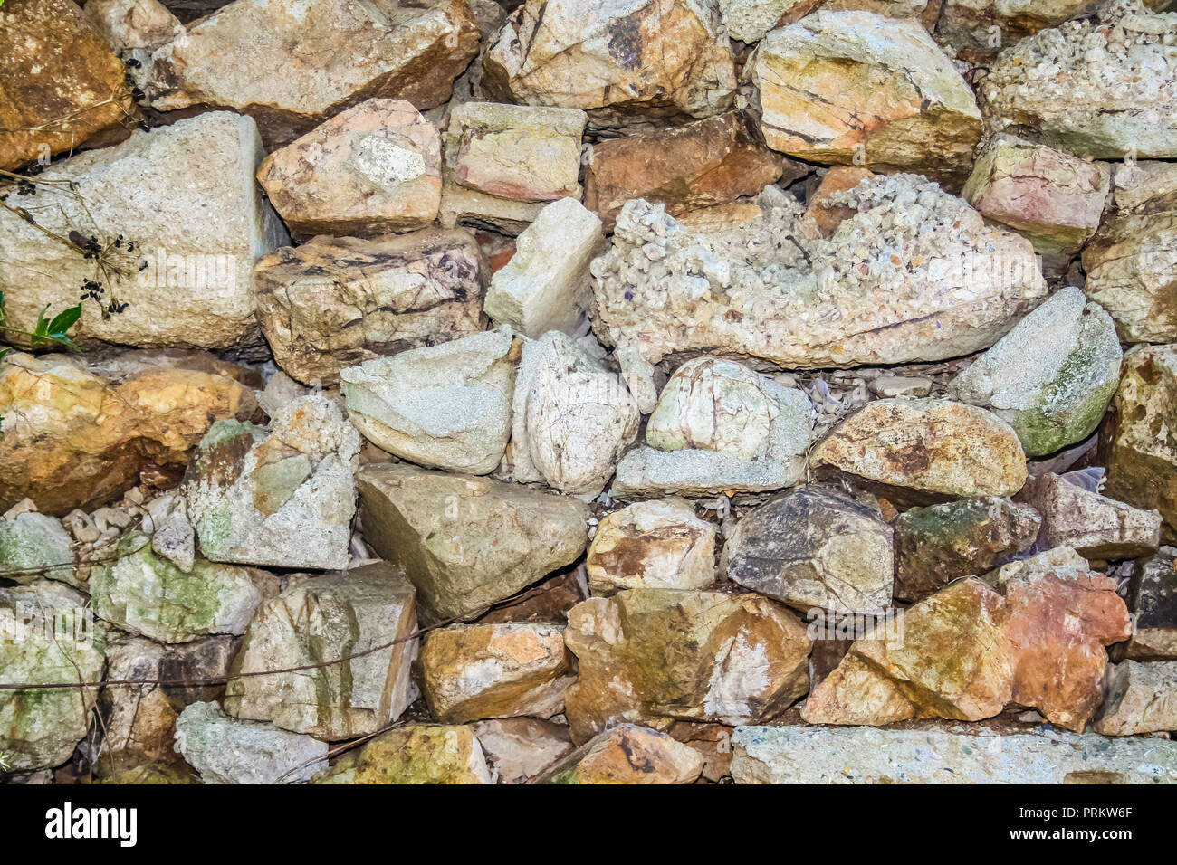 Nahaufnahme einer alten Steinmauer, mit unebenen Felsen gebaut. Stockfoto