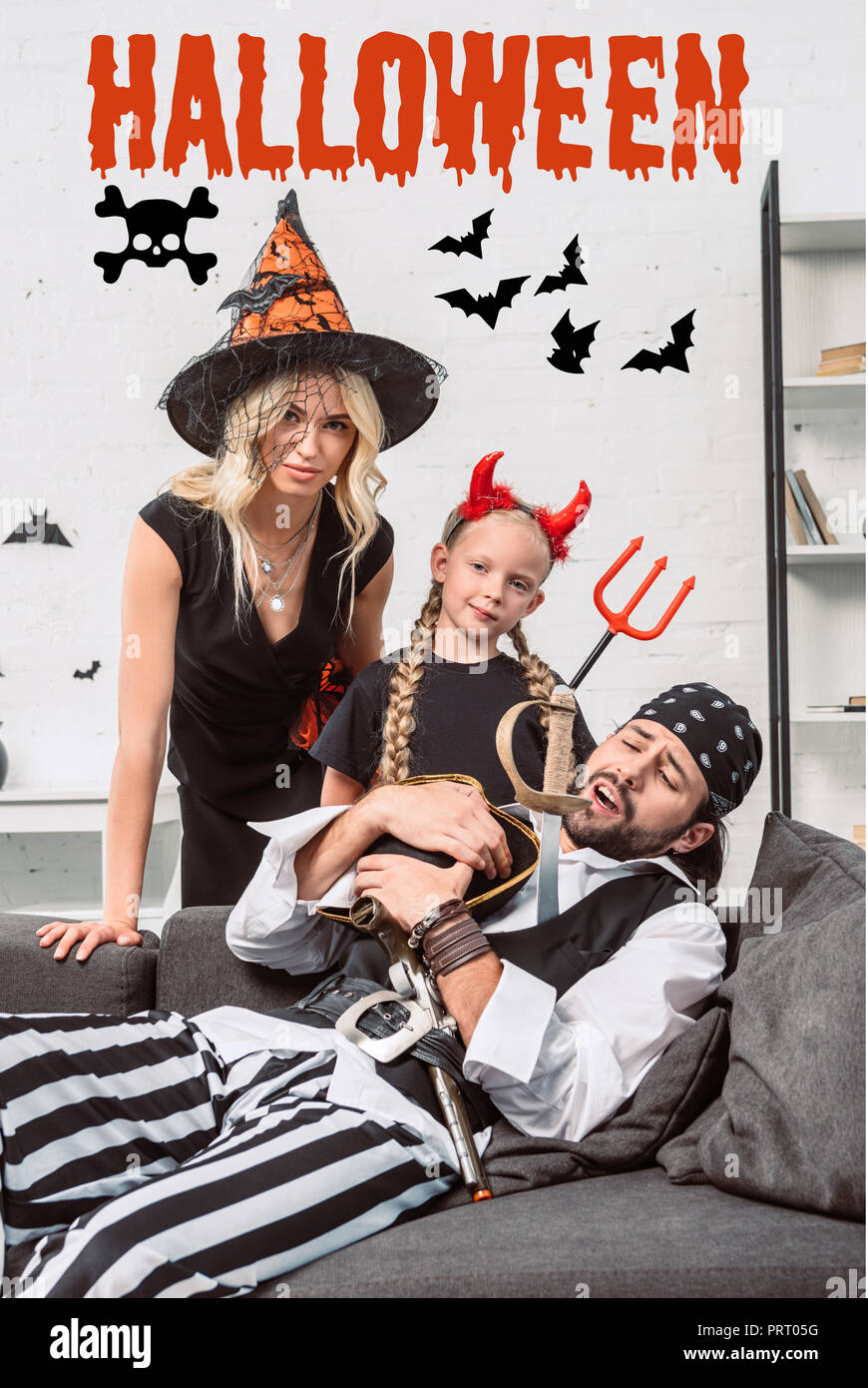 Porträt der Familie in Halloween Kostüme zu Hause mit 'Halloween'-Schriftzug Stockfoto