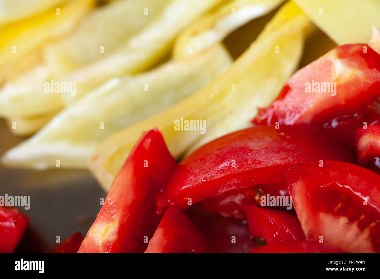 In Scheiben geschnittene Tomaten und gelbe Paprika, Makro Foto mit selektiven Fokus Stockfoto