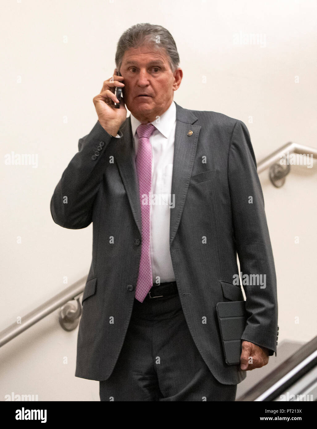 Washington DC, USA. Okt, 2018 04. United States Senator Joe Manchin III (Demokrat von West Virginia) spricht am Telefon, als er die Schritte, die in den US-Senat, der U-Bahn in das Kapitol in Washington, DC am Donnerstag, 4. Oktober 2018 ab. Manchin Stimme gilt als einer der Schlüssel für die Bestätigung der Richter Brett Kavanaugh. Credit: Ron Sachs/CNP (Einschränkung: Keine New York oder New Jersey Zeitungen oder Zeitschriften innerhalb eines 75-Meilen-Radius von New York City) | Verwendung der weltweiten Kredit: dpa Picture alliance/Alamy leben Nachrichten Stockfoto