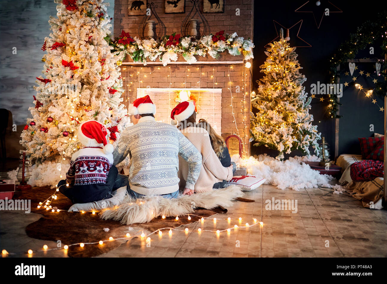 Glückliche Familie mit Kindern in einem Santa Claus hat in einem Weihnachten Stockfoto