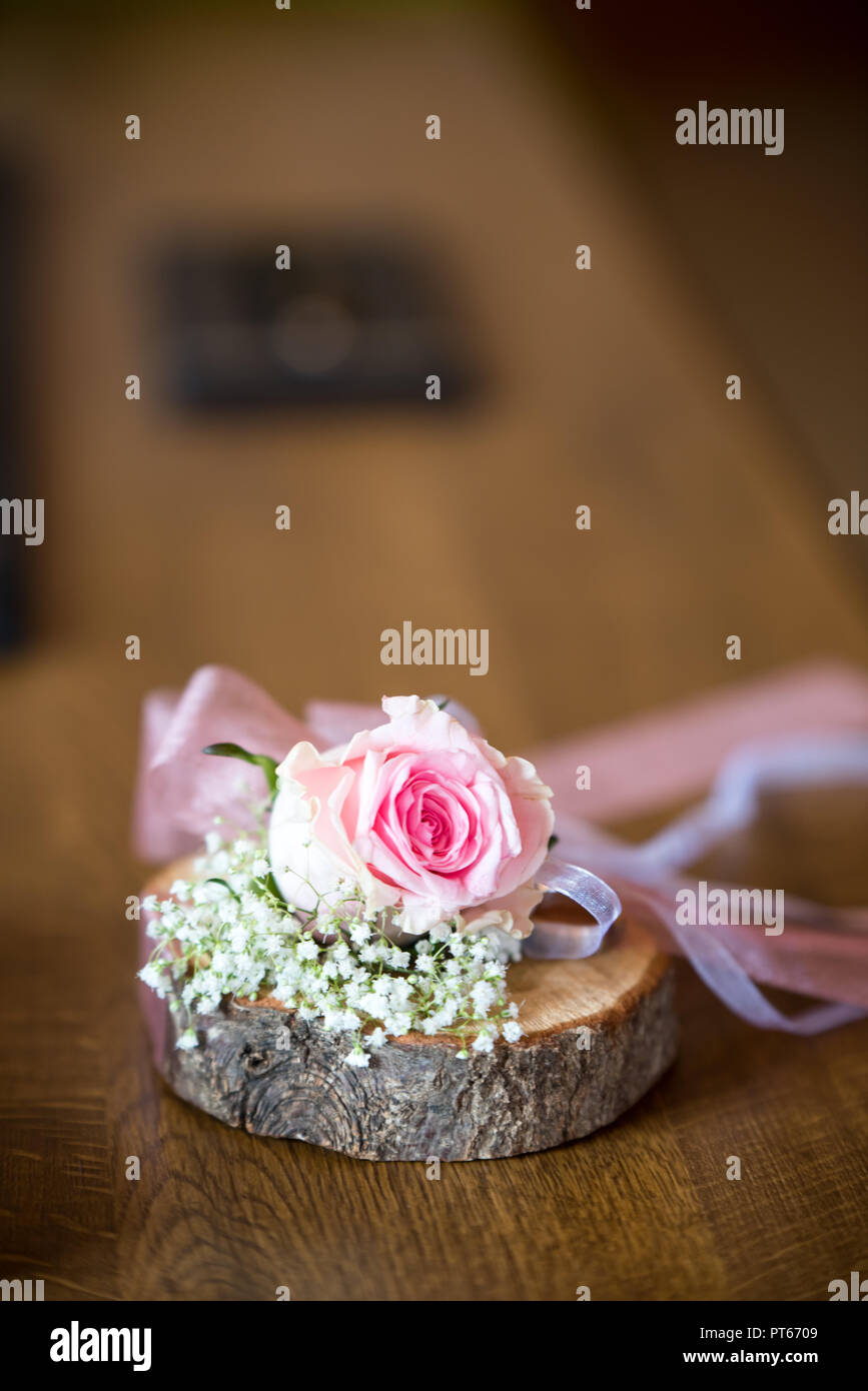 Hintergrund für den Herbst hochzeit einladung, zwei Hochzeit Ringe auf einem Stück Holz mit Rose Blume und Bänder, Platz für Text eingerichtet Stockfoto