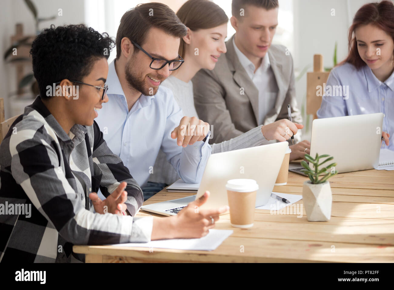 Junge Mitarbeiter am Schreibtisch im Büro in der Sitzung Stockfoto