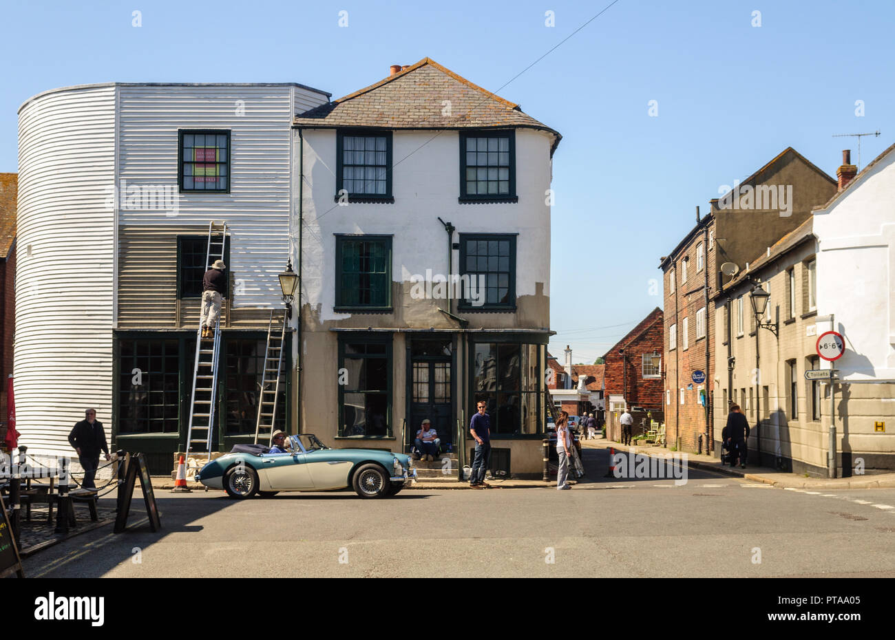 Rye, England, Großbritannien - 8. Juni 2013: Fußgänger und ein klassisches Auto pass traditionellen Häuser in den engen Gassen von Rye in East Sussex. Stockfoto