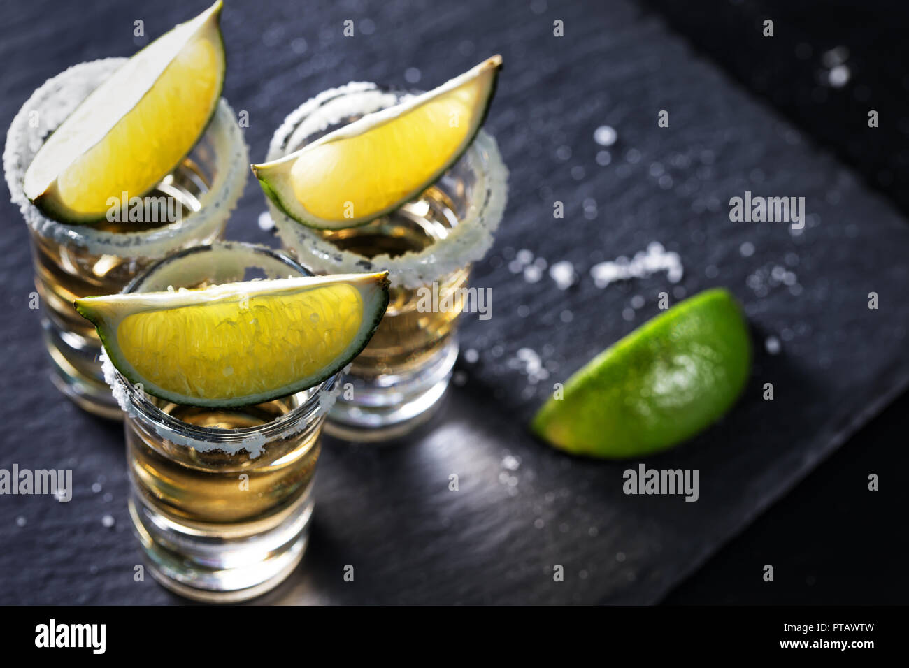 Golden mexikanischen Tequila auf schwarzem Hintergrund. Alkoholfreien Cocktail. Mexikanische traditionelle Getränk Stockfoto