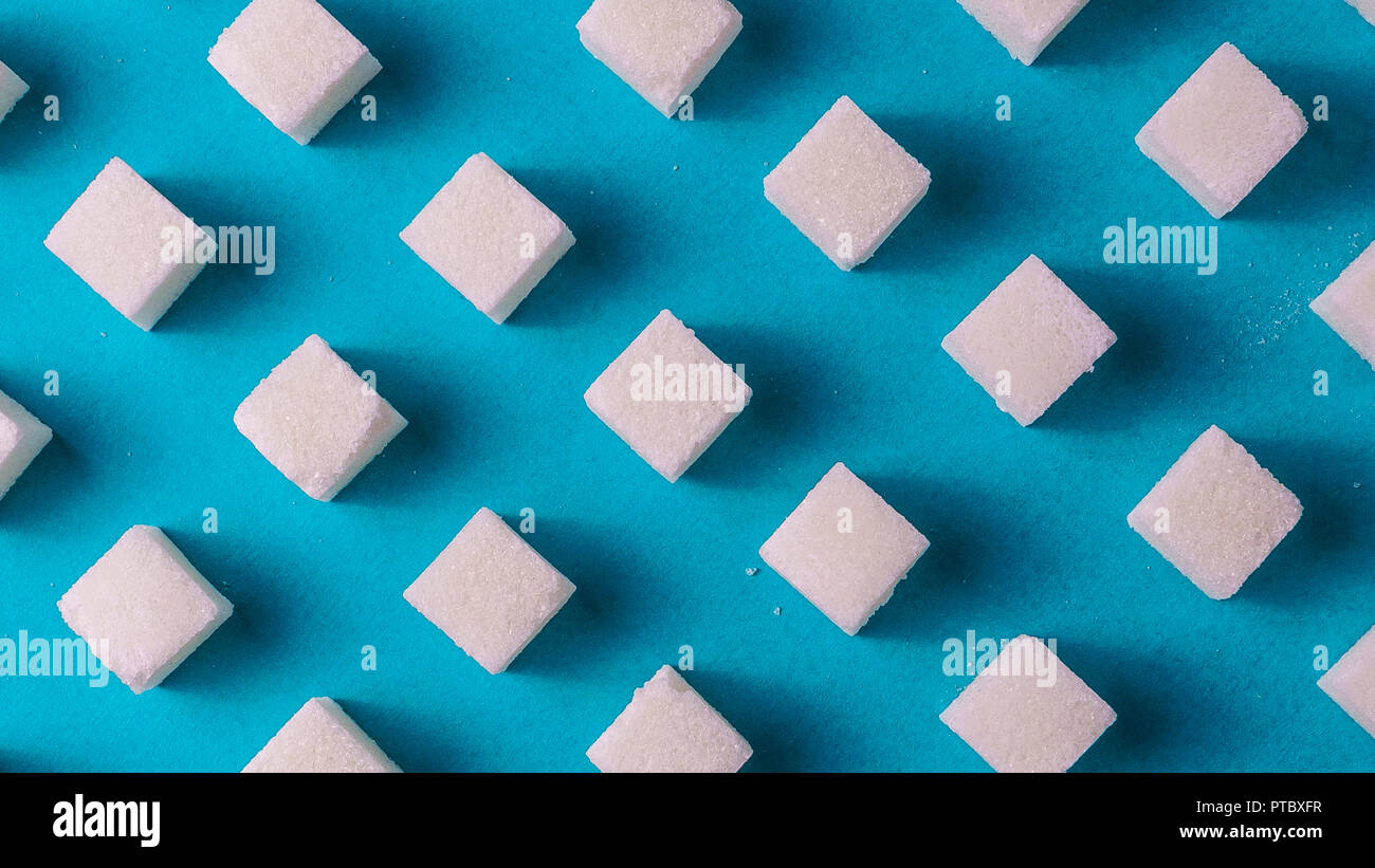 Flach auf Lebensmittel weißer Zucker Hintergrund gegen den blauen Papier. Minimalismus Stil, Banner. Stockfoto