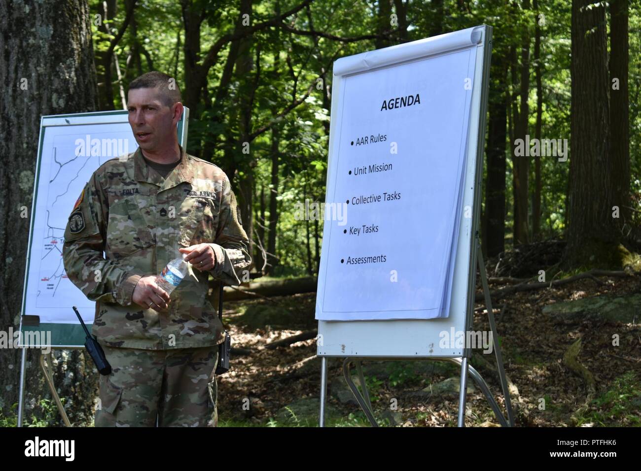 New York Army National Guard Soldat, Sgt. 1. Klasse Michael Folta, zu der 106 Regional Training Institut zugewiesen, führt eine nach der Überprüfung der Maßnahmen mit den Studenten des künftigen Führer Kurs, auf dem Camp Smith Training Website, Cortlandt Manor, N.Y., 20. Juli 2017. Die Studierenden hatten nur ein Feld training Übung abgeschlossen und Waren prüfen, was gut war, was falsch gelaufen ist, und was könnte verbessert werden. Die Ausbildung war ein Teil der New York Army National Guard zukünftige Führungskräfte Kurs, ein Pilotprogramm zur Vorbereitung Soldaten, Unteroffiziere geworden. Stockfoto