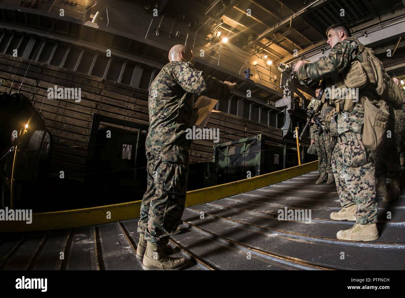 Us-Marines mit Bataillon Landung Team 2 Bataillon, 6 Marine Regiment, 26 Marine Expeditionary Unit (MEU) Check-in Vor dem Einschiffen amphibisches Fahrzeuge als Teil einer Amphibischen raid-Probe an Bord der USS Langley (LSD-41) während der Amphibischen Squadron (PHIBRON) - MEU Integration Training (PMINT) von der Küste North Carolinas, 12. Juli 2017. PMINT erlaubt die Navy-Marine Corps Team zur Verbesserung der Interoperabilität und die einzigartigen Funktionen des Amphibious Task Force Übung. Stockfoto